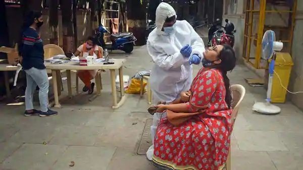 BMC health workers collect swab sample from people for COVID-19 testing in Mumbai on Saturday. (ANI)